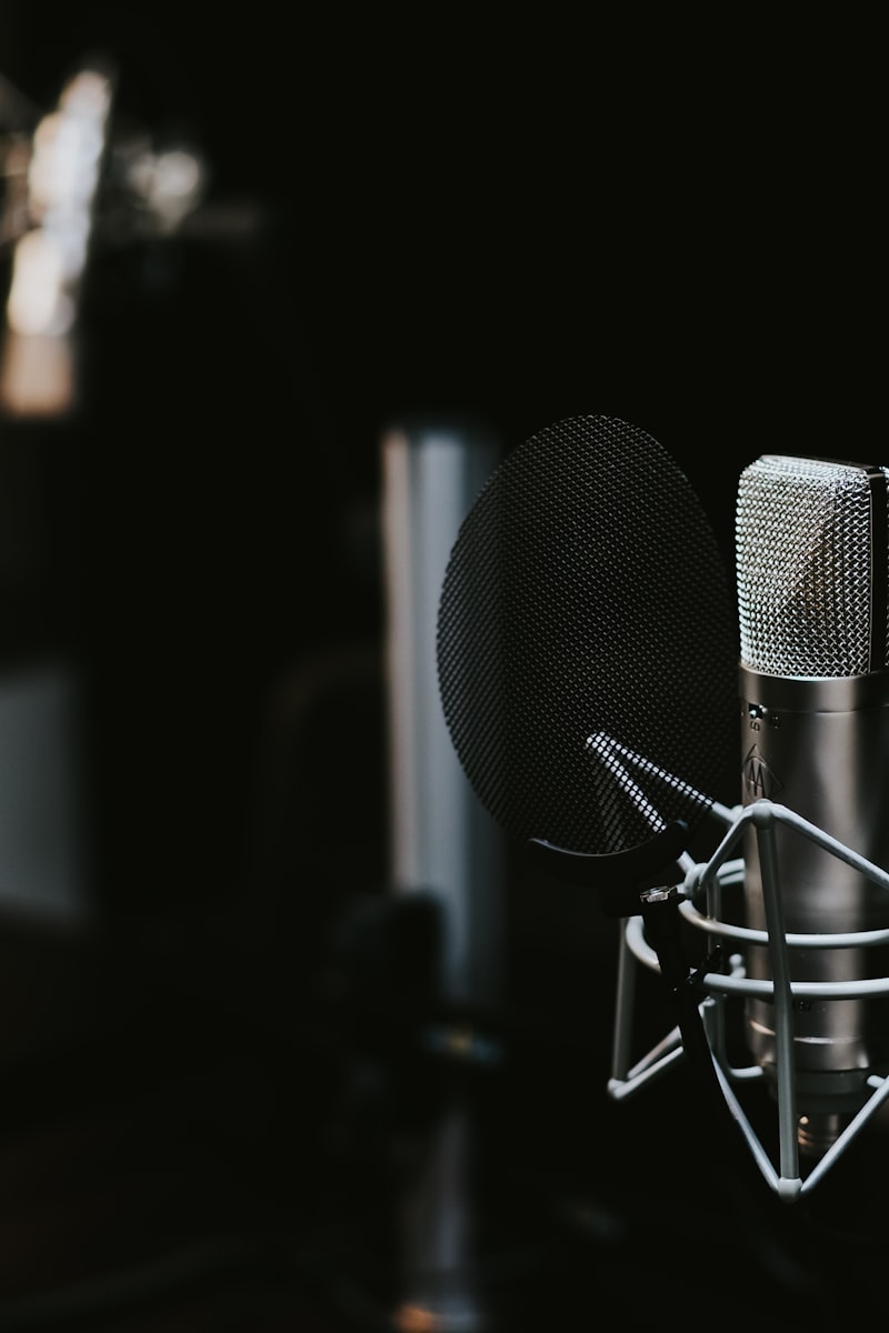 Modern podcast equipment setup on wooden desk with laptop